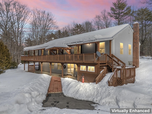 view of front of home with a wooden deck and stairs