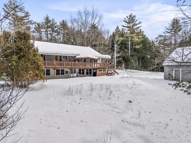 snow covered property with a deck