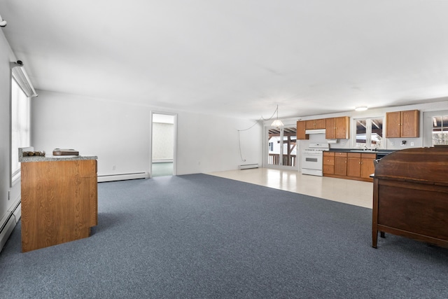 kitchen with carpet, a baseboard radiator, open floor plan, white range with gas cooktop, and under cabinet range hood