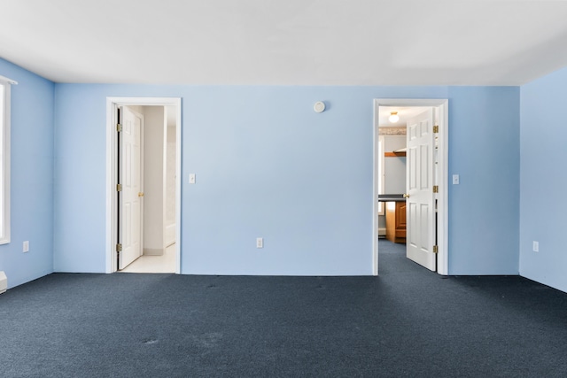 empty room with dark colored carpet