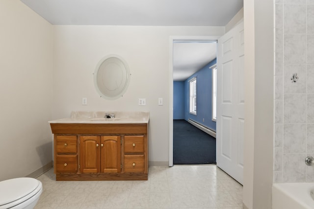 bathroom featuring toilet, baseboards, baseboard heating, and vanity