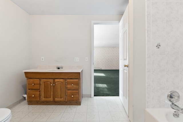 bathroom with toilet, a baseboard heating unit, vanity,  shower combination, and baseboards