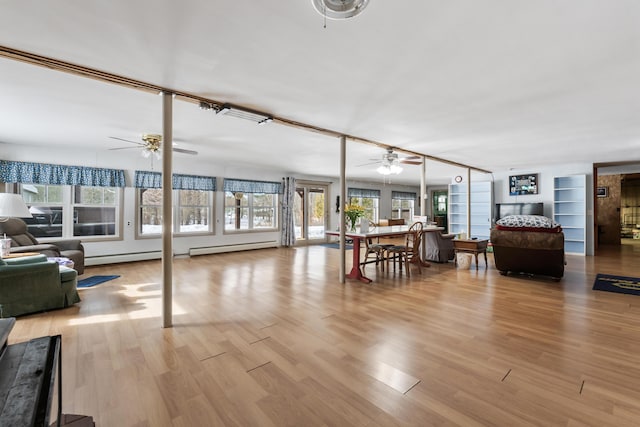 dining area with light wood finished floors, a ceiling fan, and built in features