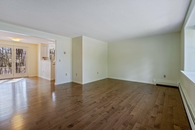 unfurnished living room with baseboards, a baseboard heating unit, and dark wood finished floors