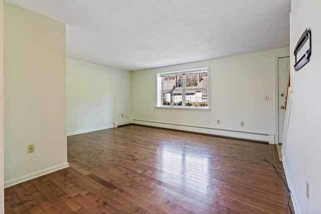 unfurnished room with baseboards, a textured ceiling, baseboard heating, and hardwood / wood-style floors