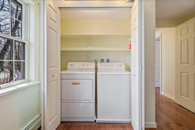 laundry area with laundry area, dark wood-style floors, washer and dryer, and baseboard heating