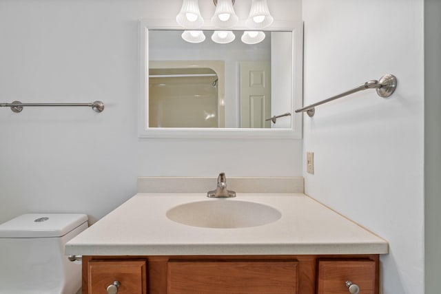 bathroom with vanity, a shower, and toilet