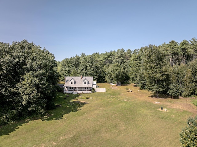 bird's eye view with a wooded view