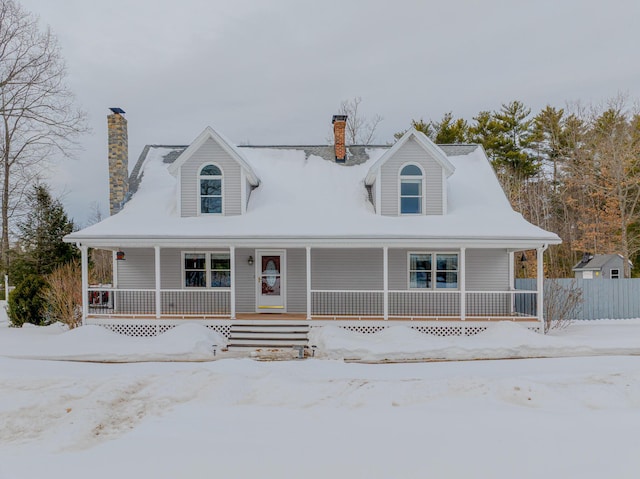 view of front of home with covered porch and a chimney