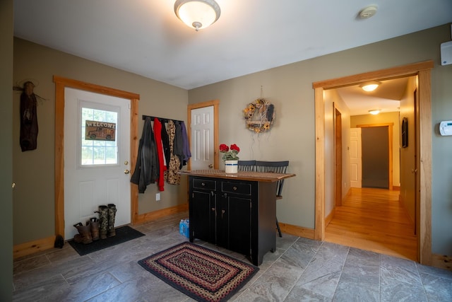 entryway featuring baseboards