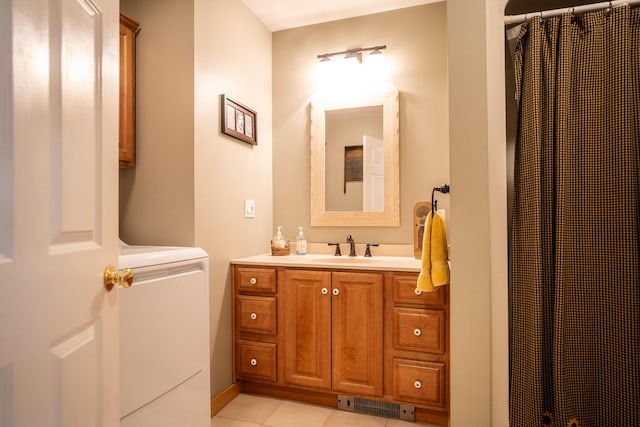 full bath featuring washer / dryer, visible vents, a shower with shower curtain, tile patterned flooring, and vanity