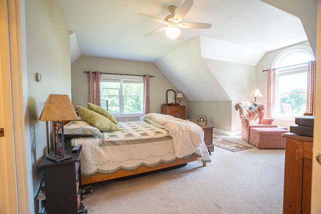 carpeted bedroom featuring lofted ceiling and ceiling fan