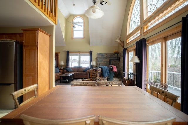 dining space featuring high vaulted ceiling and a wealth of natural light