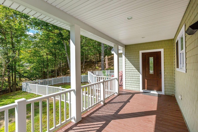 deck featuring covered porch and fence