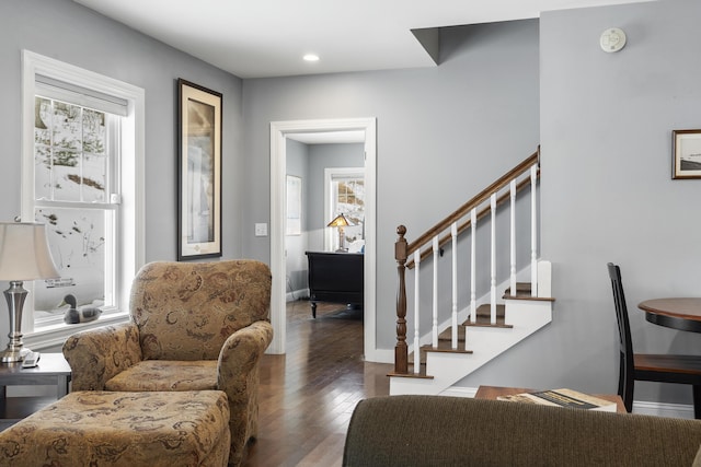 interior space with plenty of natural light, stairs, baseboards, and hardwood / wood-style floors