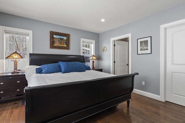 bedroom with dark wood-style floors, baseboards, and recessed lighting