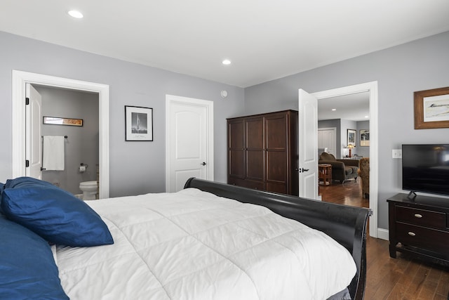 bedroom with dark wood-type flooring, ensuite bath, and recessed lighting