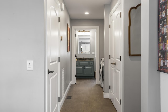 corridor with recessed lighting, visible vents, and washer and clothes dryer