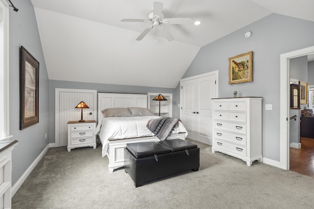 bedroom with carpet, vaulted ceiling, baseboards, and ceiling fan