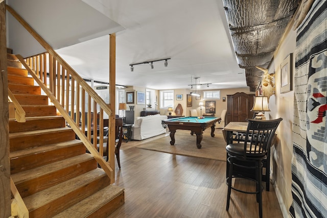 playroom with wood finished floors, billiards, and track lighting