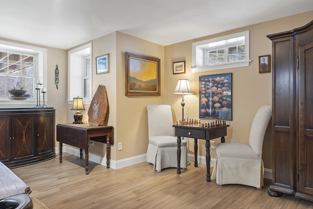 sitting room with light wood-type flooring and baseboards