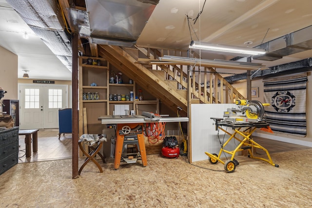 basement featuring stairs, wood finished floors, and french doors