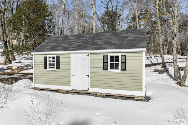 snow covered structure featuring an outdoor structure