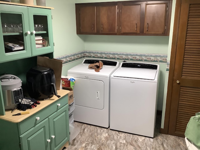 laundry room with washing machine and dryer and cabinet space