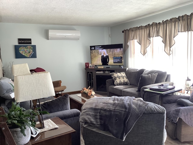 living area featuring a fireplace, a textured ceiling, and a wall mounted AC