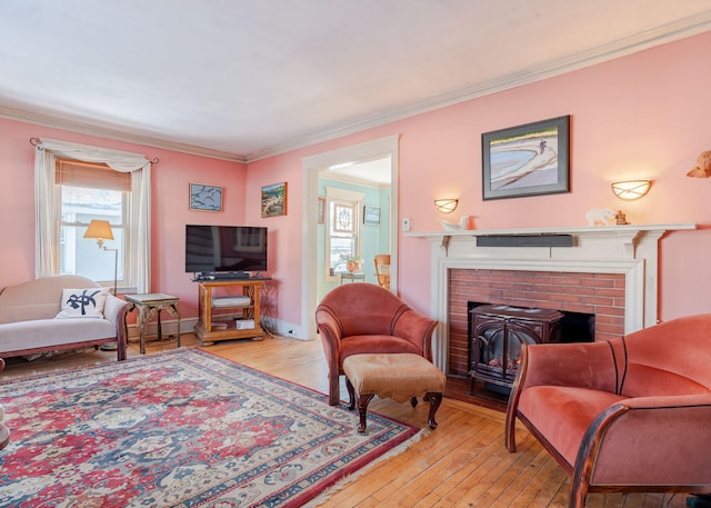 living room featuring wood-type flooring, baseboards, and crown molding