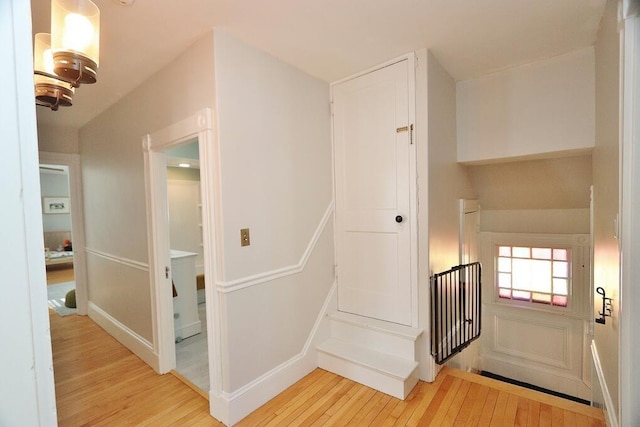 interior space with light wood-style floors and an upstairs landing