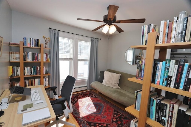 office featuring a baseboard radiator, ceiling fan, and wood finished floors