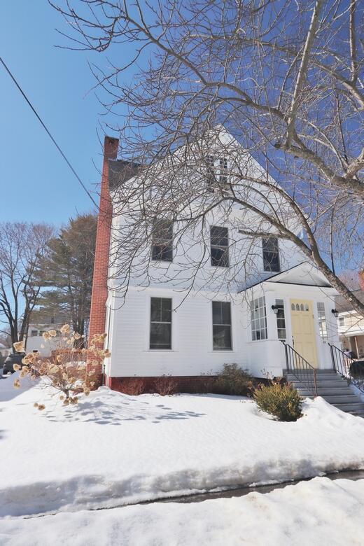 view of front of house featuring a chimney