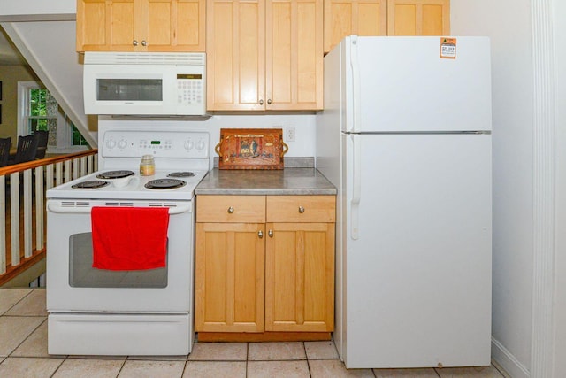 kitchen featuring light tile patterned floors, light brown cabinetry, and white appliances