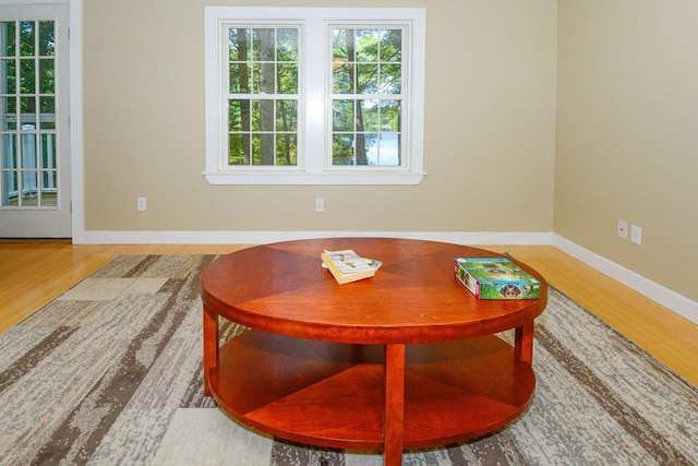 living area with wood finished floors and baseboards