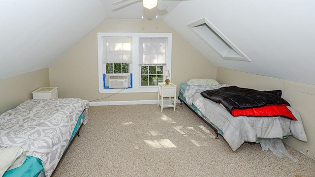 bedroom with cooling unit, vaulted ceiling with skylight, carpet, and ceiling fan