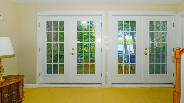 doorway to outside featuring baseboards and french doors