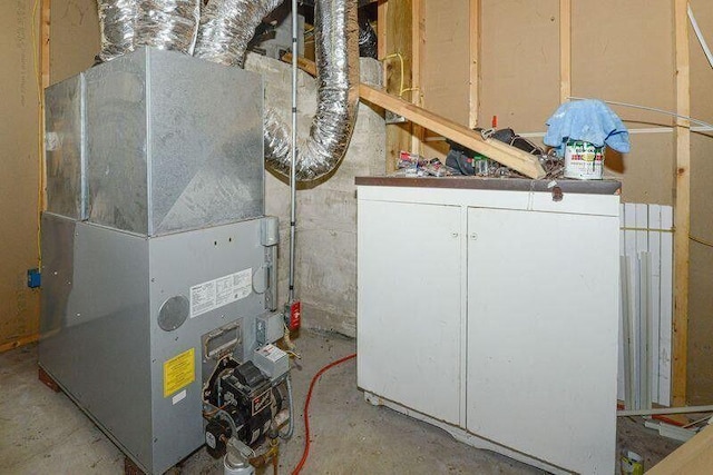 utility room with heating unit