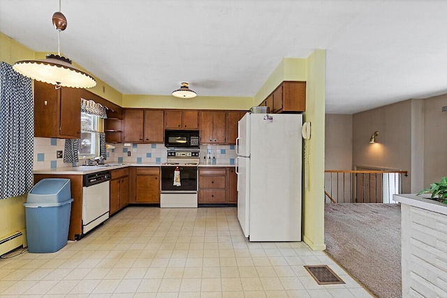 kitchen with white appliances, visible vents, light countertops, backsplash, and pendant lighting