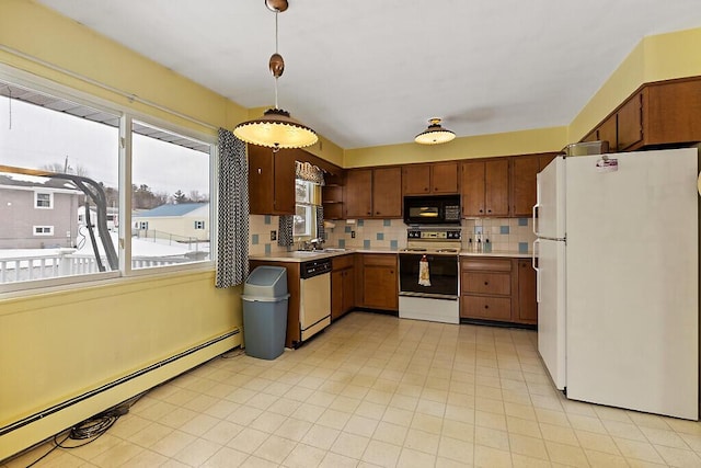 kitchen with black microwave, dishwashing machine, a baseboard radiator, range with electric cooktop, and freestanding refrigerator