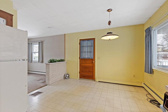 entrance foyer featuring a baseboard heating unit and visible vents