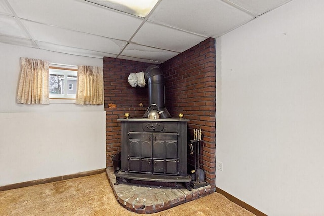 interior details featuring a wood stove, baseboards, and carpet flooring