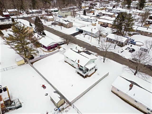 snowy aerial view with a residential view