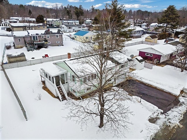 snowy aerial view with a residential view