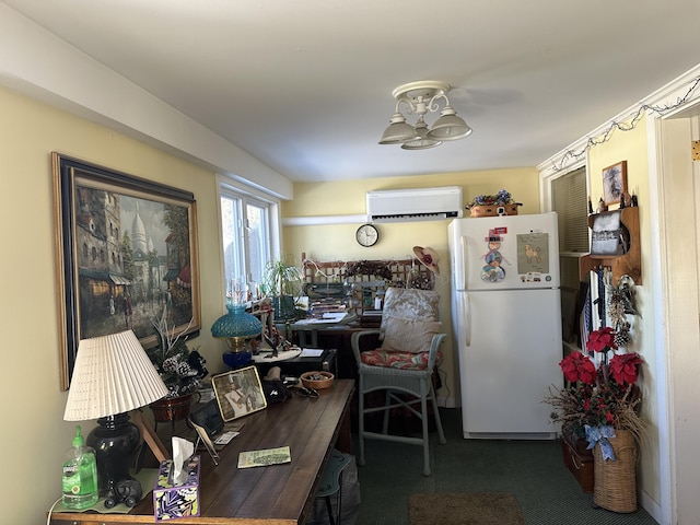 kitchen featuring carpet, an AC wall unit, and freestanding refrigerator