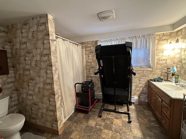 bathroom with baseboard heating, baseboards, vanity, and toilet