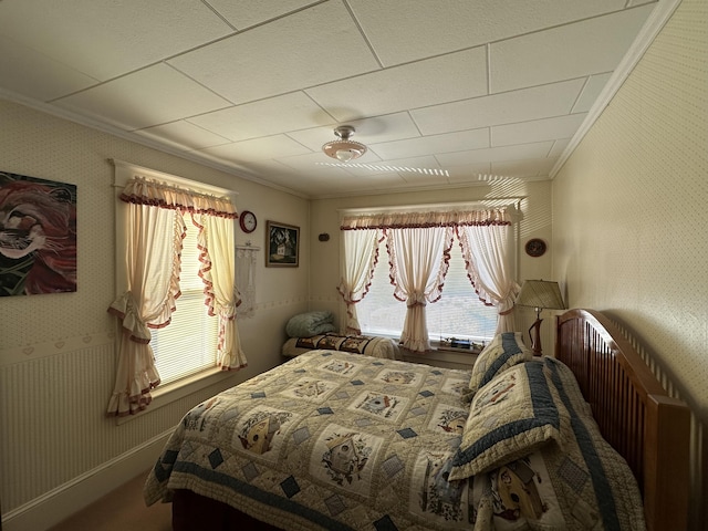 bedroom featuring ornamental molding, baseboards, and wallpapered walls