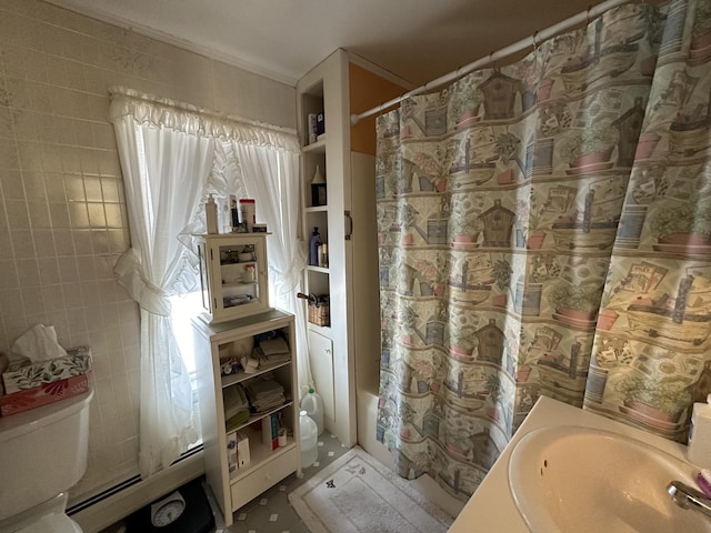 bathroom with a baseboard radiator, a sink, and toilet