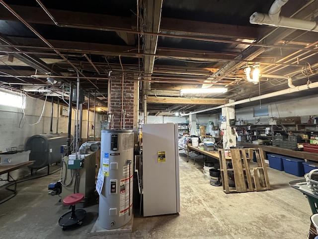 below grade area featuring freestanding refrigerator, water heater, and heating fuel