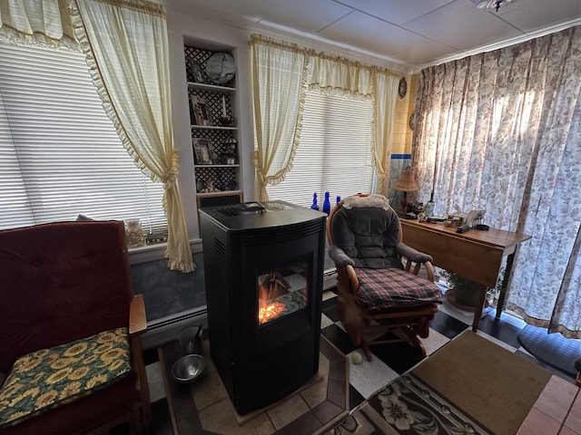 sitting room featuring tile patterned flooring, built in features, and crown molding